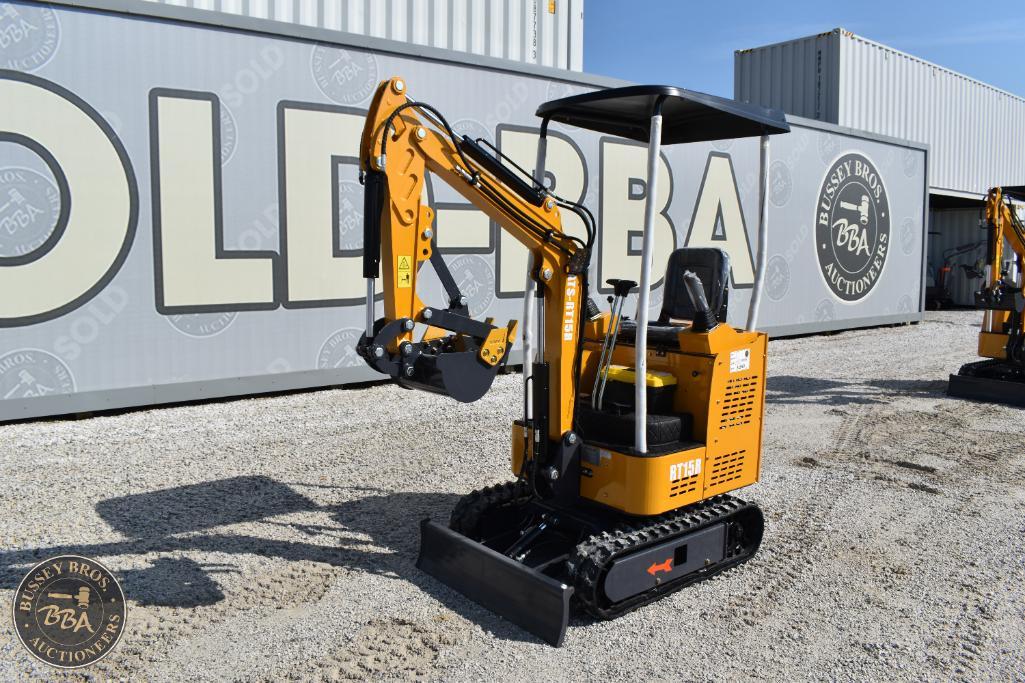 Compact yellow mini excavator with black tracks at Bussey Bros Auctioneers yard.