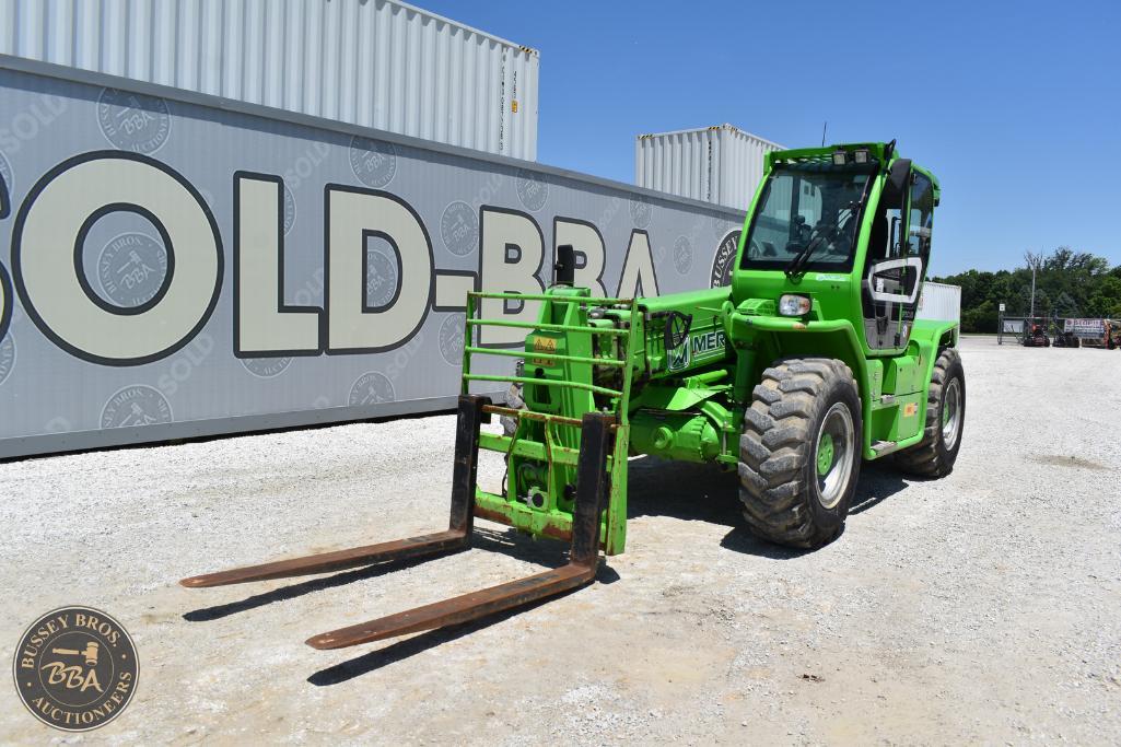 Green forklift with extended forks at Bussey Bros Auctioneers, ready for equipment handling and tran.