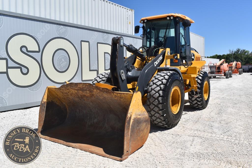 Yellow front loader excavator at Bussey Bros Auctioneers yard.