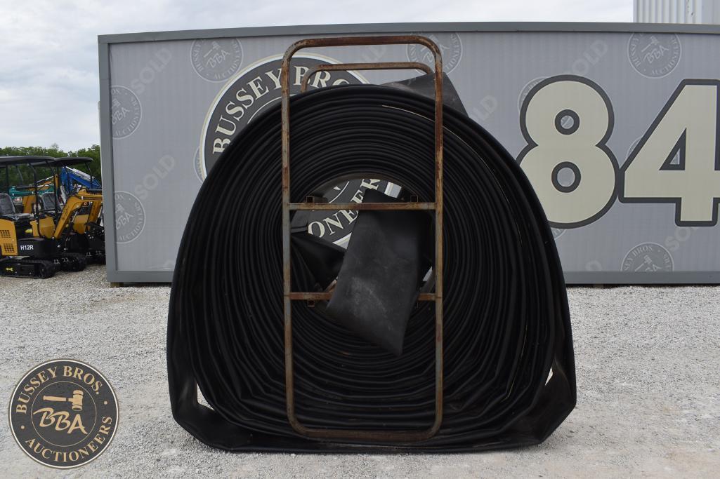 Coiled industrial rubber hose at Bussey Bros Auctioneers, ready for sale or use.