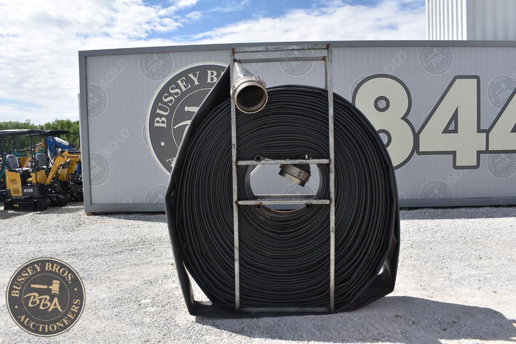 Large coiled black industrial hose on metal frame at Bussey Bros Auctioneers.