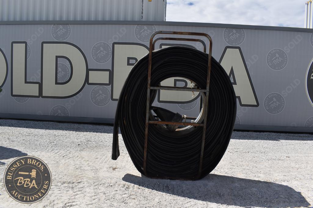 Coiled black industrial cable displayed outdoors at Bussey Bros Auctioneers.