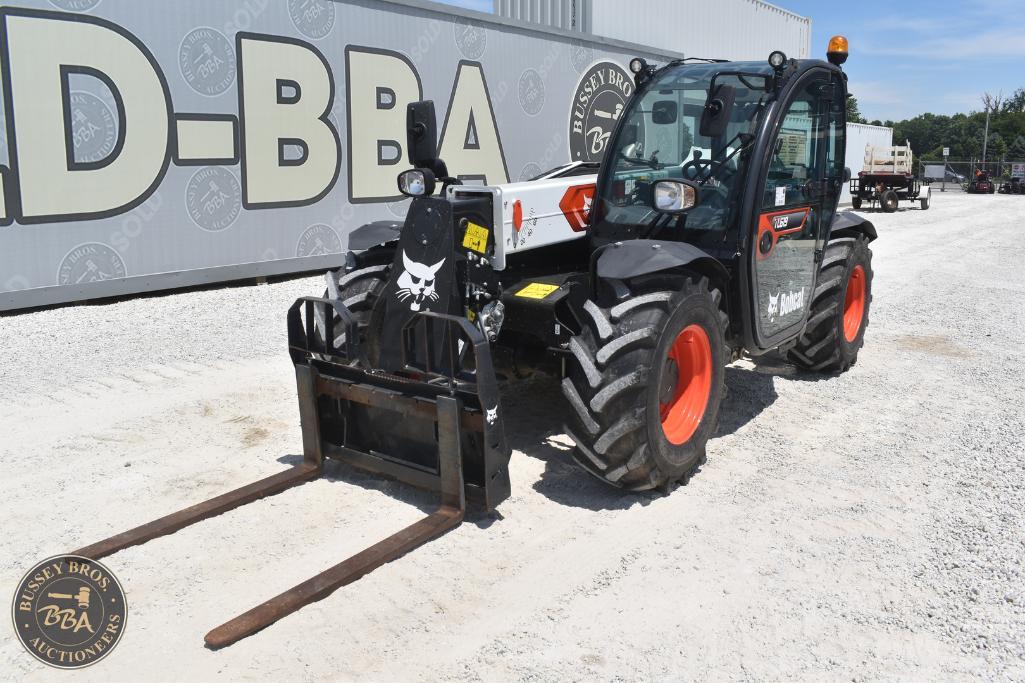 Modern compact loader with forks at Bussey Bros Auctioneers yard.