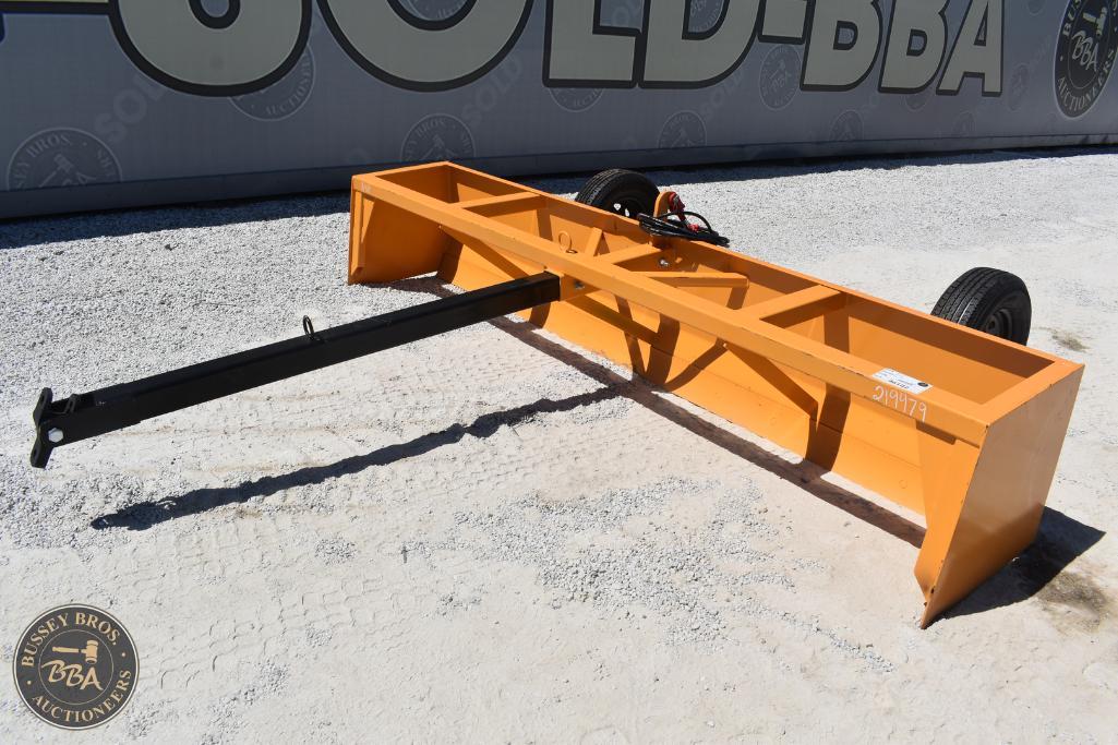 Heavy-duty orange farm blade for land clearing and grading at auction.