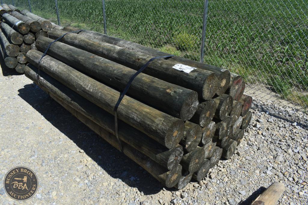 Stacked timber logs available for auction at Bussey Bros Auctioneers, ideal for construction or fire.