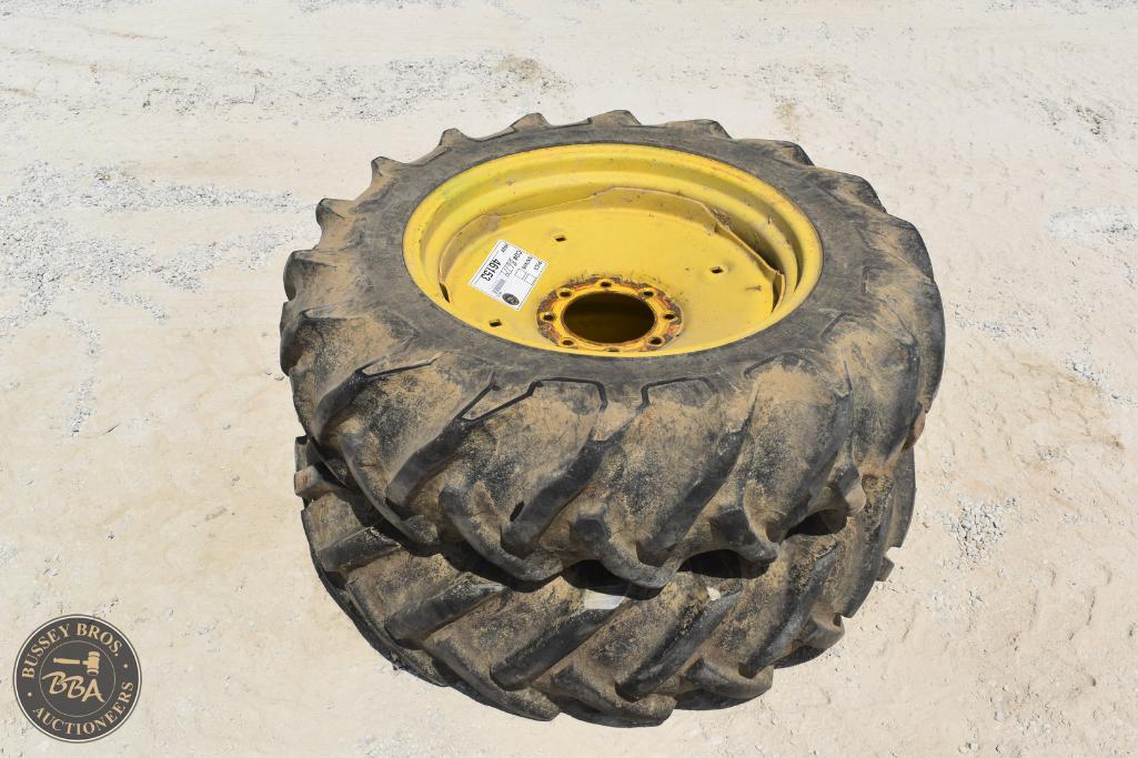 Farm tractor tire with yellow rim for agricultural machinery.