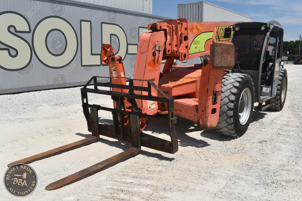 Heavy forklift with orange boom and black cab at Bussey Bros Auctioneers.