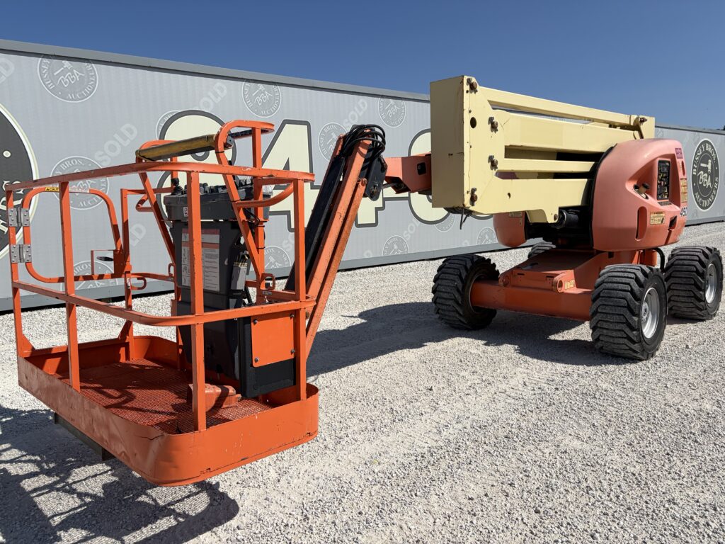 Orange and yellow aerial lift platform for heavy equipment auction.