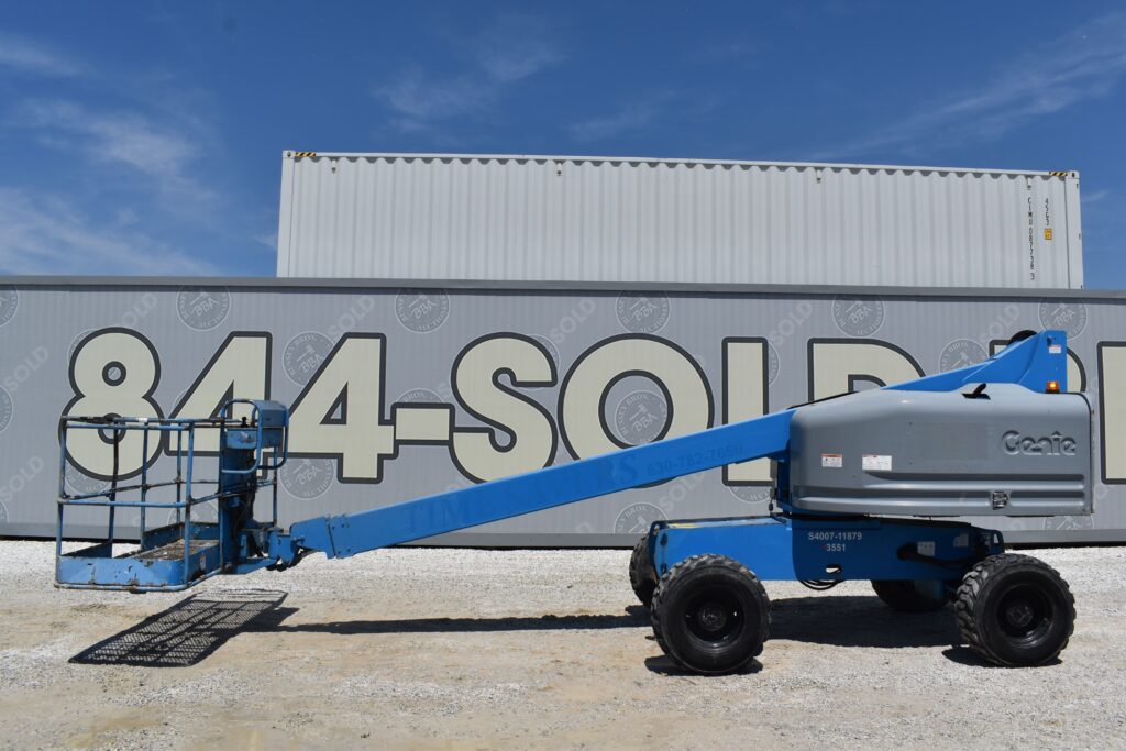 Blue Genie boom lift with extended arm at heavy equipment auction.