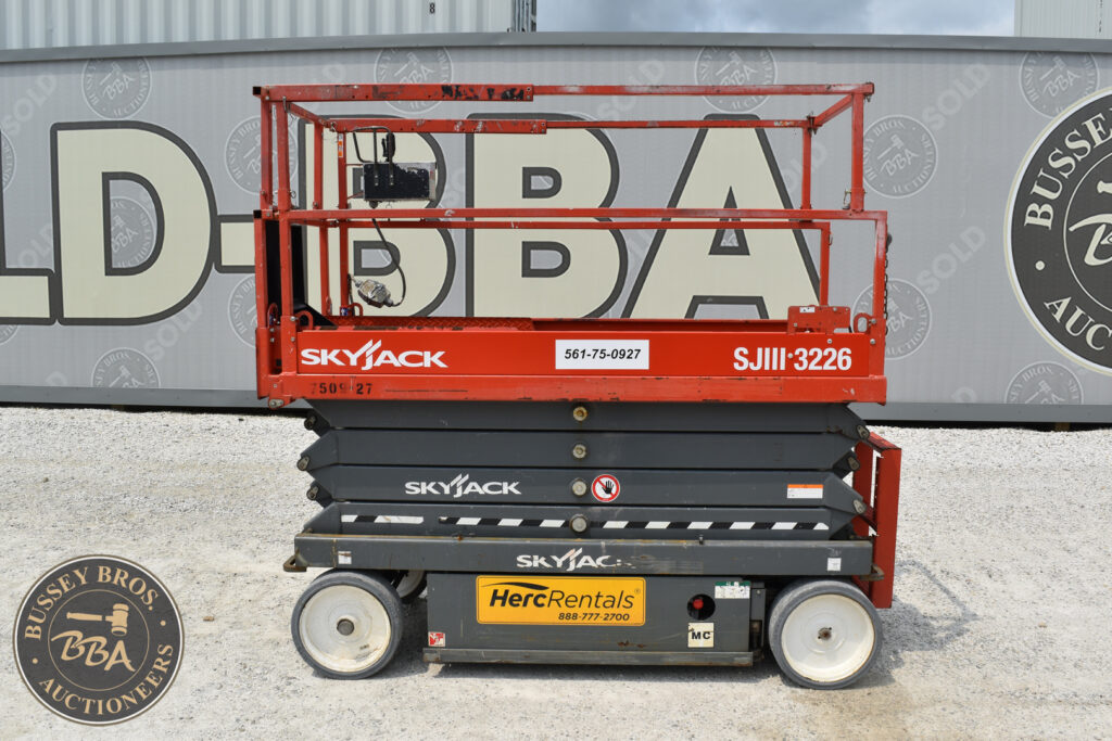 Red Skyjack scissor lift at heavy equipment auction.