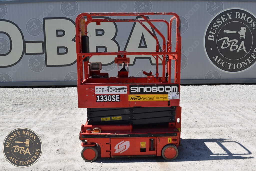 Red Sinoboom 1330SE scissor lift at heavy equipment auction.