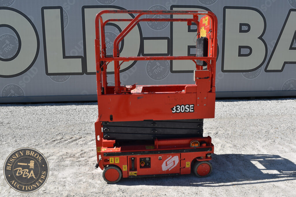 Red JLG 330SE electric scissor lift for auction at Bussey Bros.
