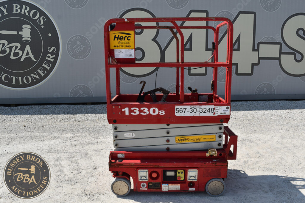 Red Herc Rentals scissor lift at heavy equipment auction.
