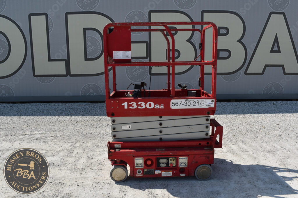 Red 1330SE scissor lift at heavy equipment auction.