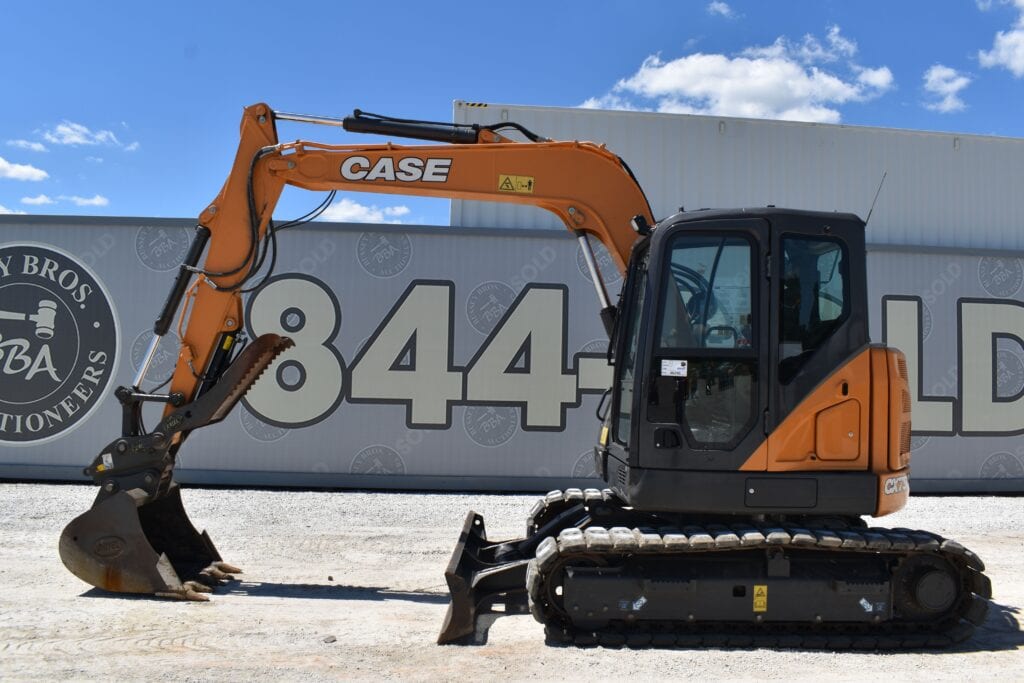 Orange Case mini excavator on display at heavy equipment auction.
