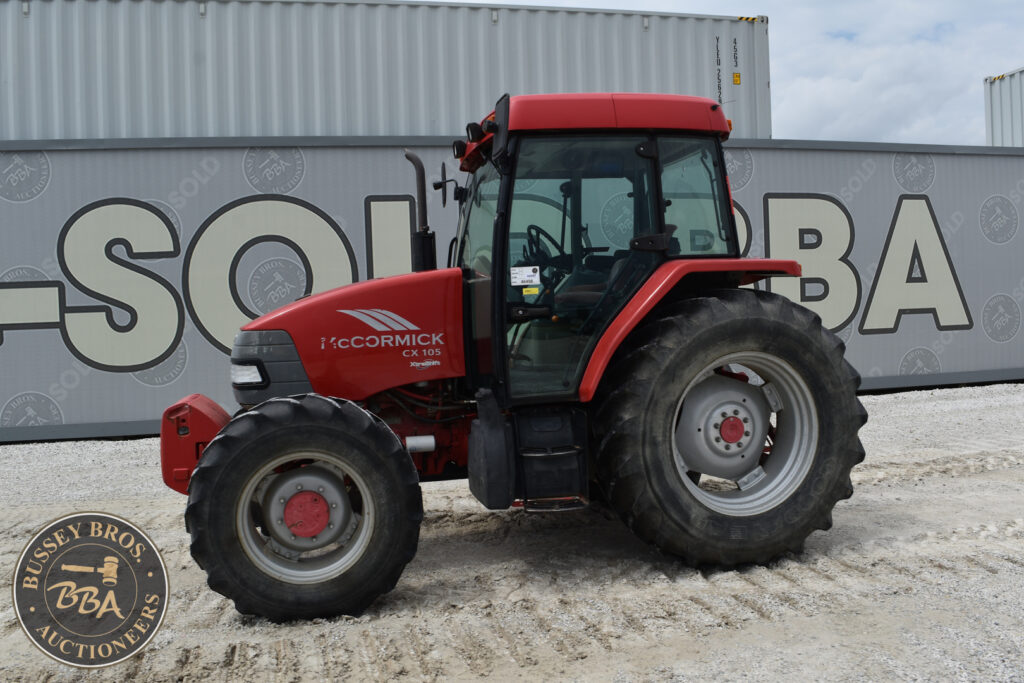 Red McCormick CX105 tractor at heavy equipment auction.