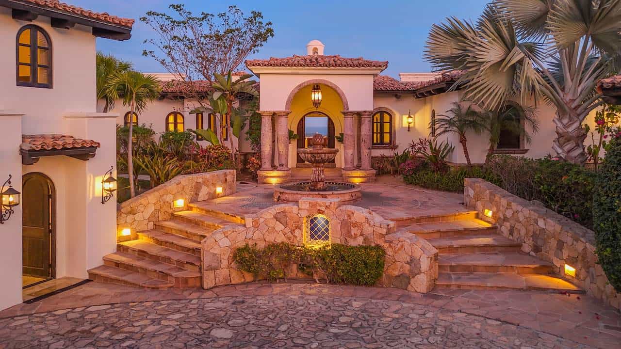Elegant Stone Entryway And Fountain At A Luxury Cabo Del Sol Home At Sunset, Representing The Upscale Service You Receive When You Contact Cabo Del Sol Real Estate Experts.
