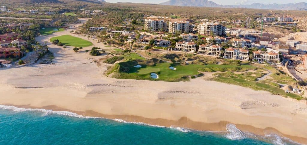 Aerial View Of Cabo Del Sol’s Luxury Beachfront Homes, Oceanfront Golf Course, And Resort-Style Community In Los Cabos