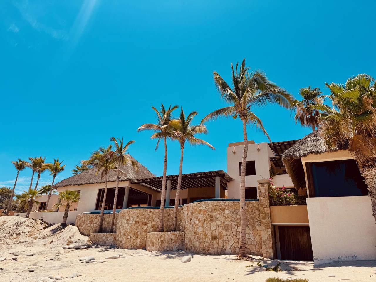 Luxury Beachfront Villa With Palm Trees And Ocean Views At Cabo Del Sol, Mexico, Showcasing High-End Architecture And Tropical Surroundings.