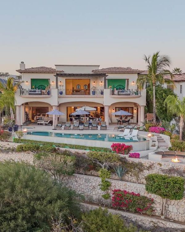 Aerial view of Casa Alegria, a luxury two-story oceanview villa in Las Colinas, Cabo del Sol, featuring an infinity pool, outdoor lounge areas, and panoramic Sea of Cortez views.