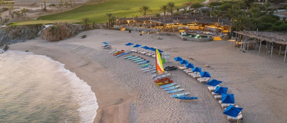 Cabodelsol-Event-1 Beach With Paddleboards And Lounge Chairs At Cabo Del Sol Resort In Mexico, Showcasing Luxury Beachfront Amenities And Scenic Ocean Views.