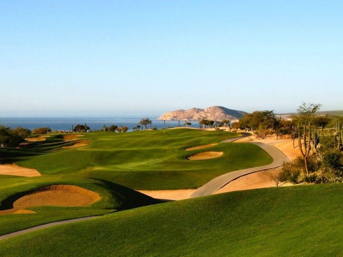 Scenic Cabo Real Golf Course Hole With Rolling Fairways And Ocean Horizon In Los Cabos