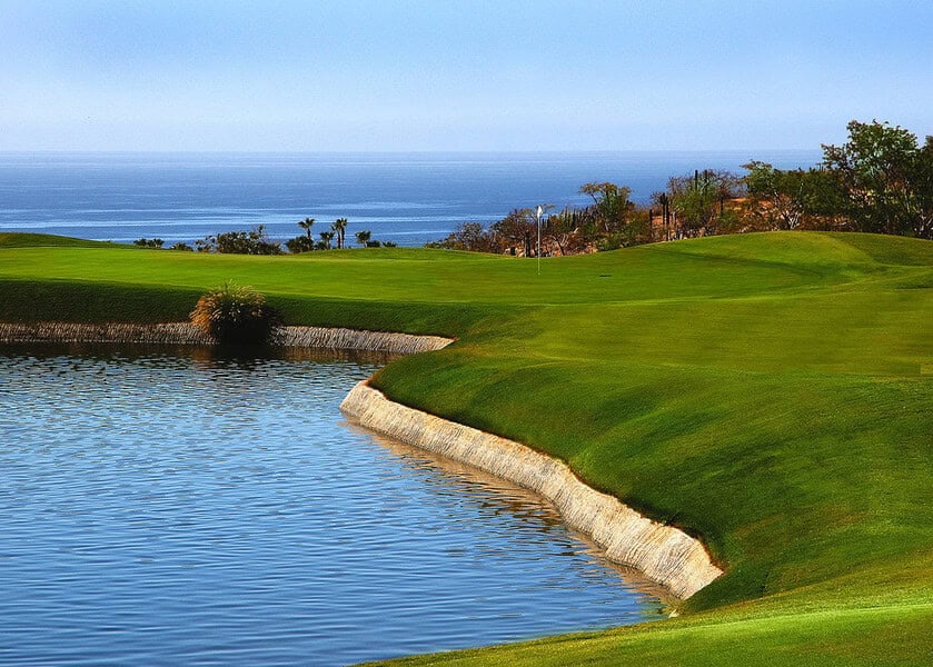 Cabo Real Golf Course Hole Framed By Desert Terrain, Palm Trees, And Ocean Views