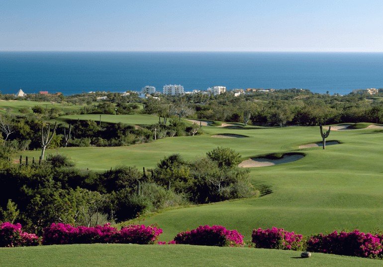 “Aerial view of Cabo Real Golf Course fairways overlooking the Sea of Cortez and coastal resorts in Los Cabos, Mexico”