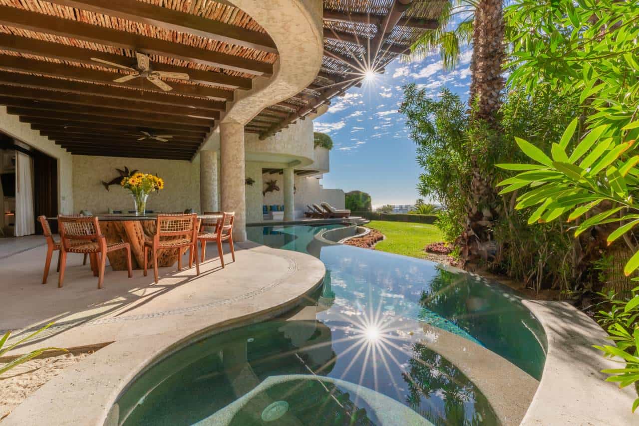 Luxury Cabo Real Waterfront Villa With Infinity Pool, Lush Tropical Landscaping, And Spacious Outdoor Living Area, Perfect For Relaxing And Enjoying Stunning Views In Cabo Real Real Estate Listings.