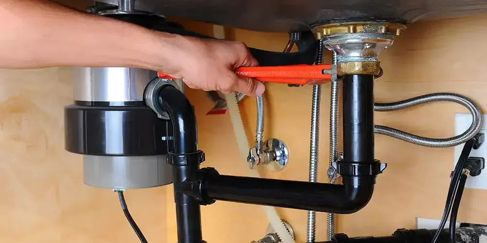 Plumber-Installing-Garbage-Disposal-Under-Kitchen-Sink-Service