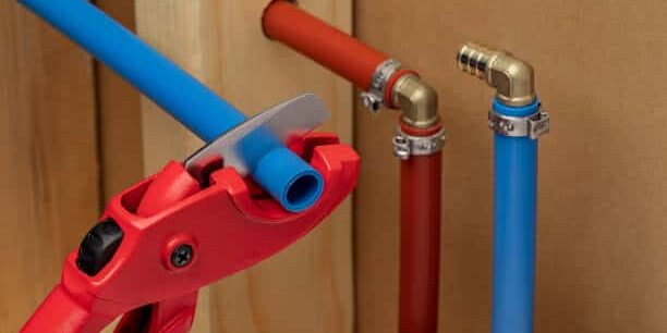 Plumber-Cutting-PEX-Pipe-During-Repiping-Service