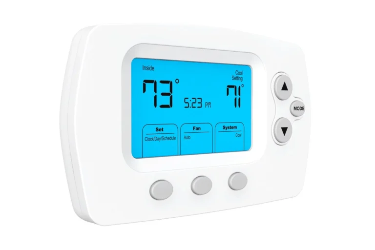 White digital thermostat displaying an indoor temperature of 73°F, a cool setting of 71°F, and the time 5:23 PM with control buttons on the right and below the screen.