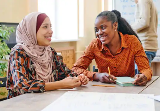 Women engaging in a supportive counselling session in a bright, welcoming office.