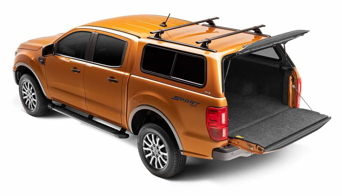 Orange pickup truck with open bed and sleek design, perfect for sports equipment and outdoor activities.
