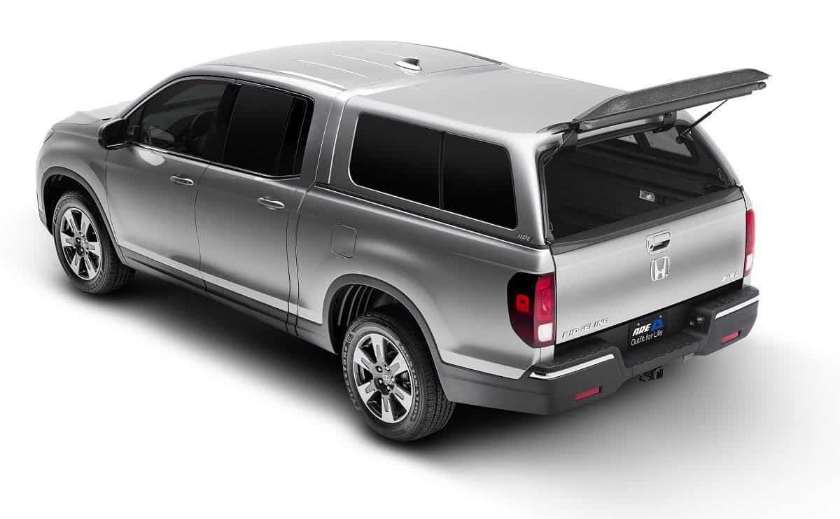 Silver Honda Ridgeline pickup truck with open bed and roof rack for outdoor gear.