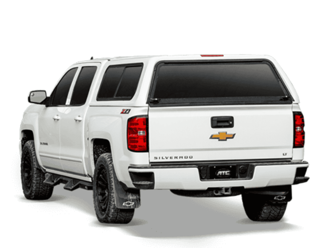 White Chevrolet Silverado pickup truck with sporty tires, tinted windows, and Chevrolet emblem.
