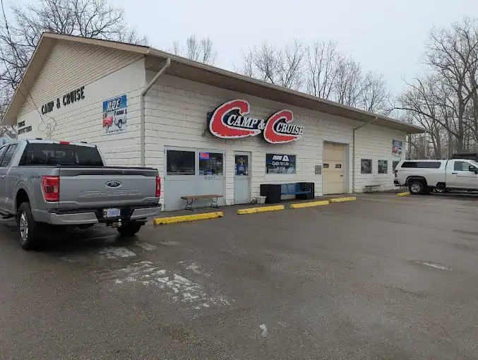 Large exterior view of Camp & Cruise with vehicles parked in front.