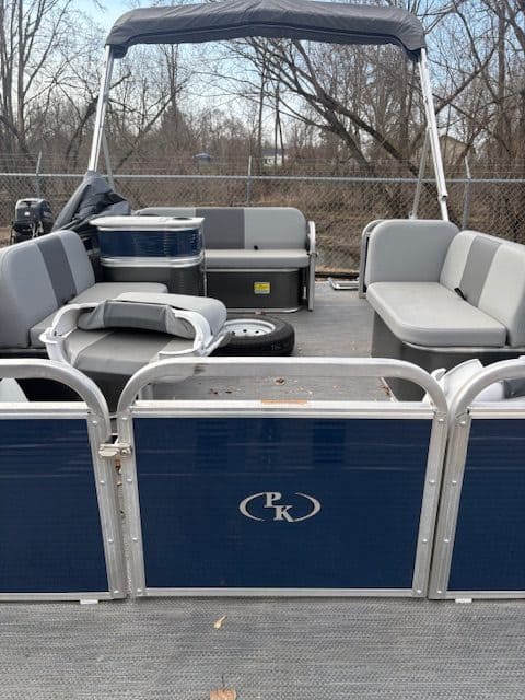 Pontoon boat with comfortable seating and canopy for outdoor leisure.