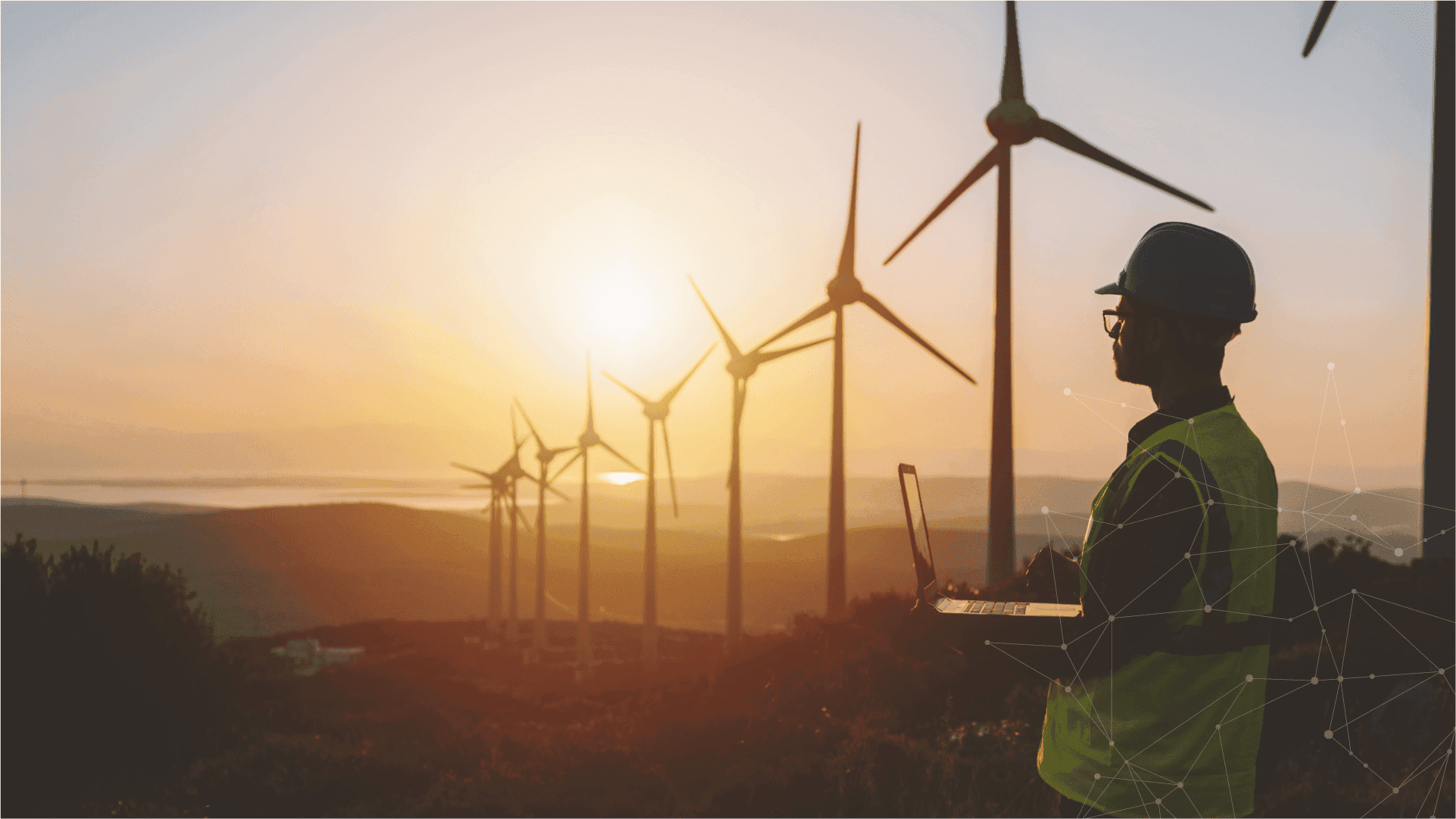 Energieexperte analysiert Windkraftanlagen im Sonnenuntergang – Symbol für digitale Energiewirtschaft und nachhaltige Zukunft