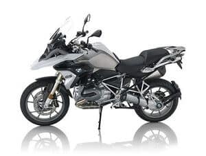 Motorcycle parked outdoors on a city street under clear sky.