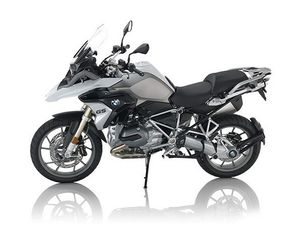 Motorcycle parked outdoors on a city street under clear sky.