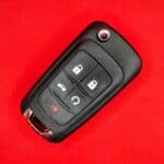 Keyless car remote on red background.