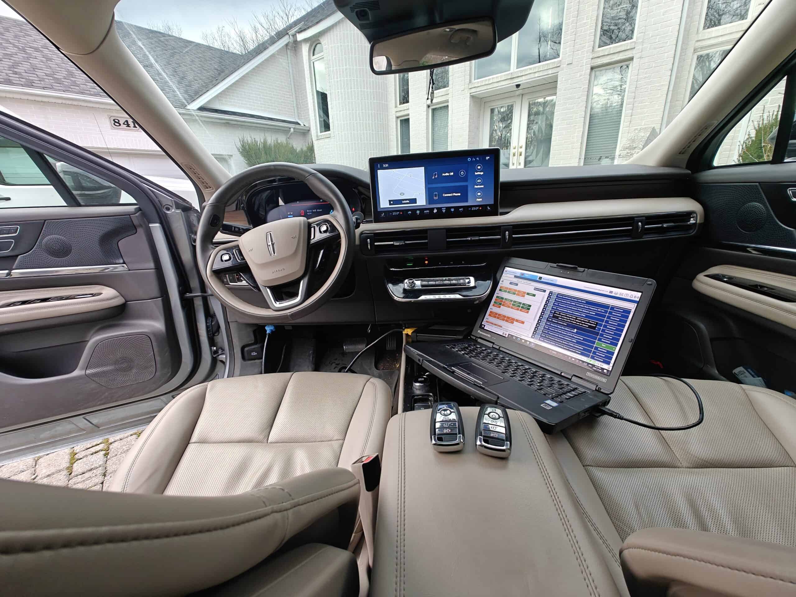 Remote car interior with diagnostic laptop and key fobs, Auto repair and locksmith services in LaSalle.