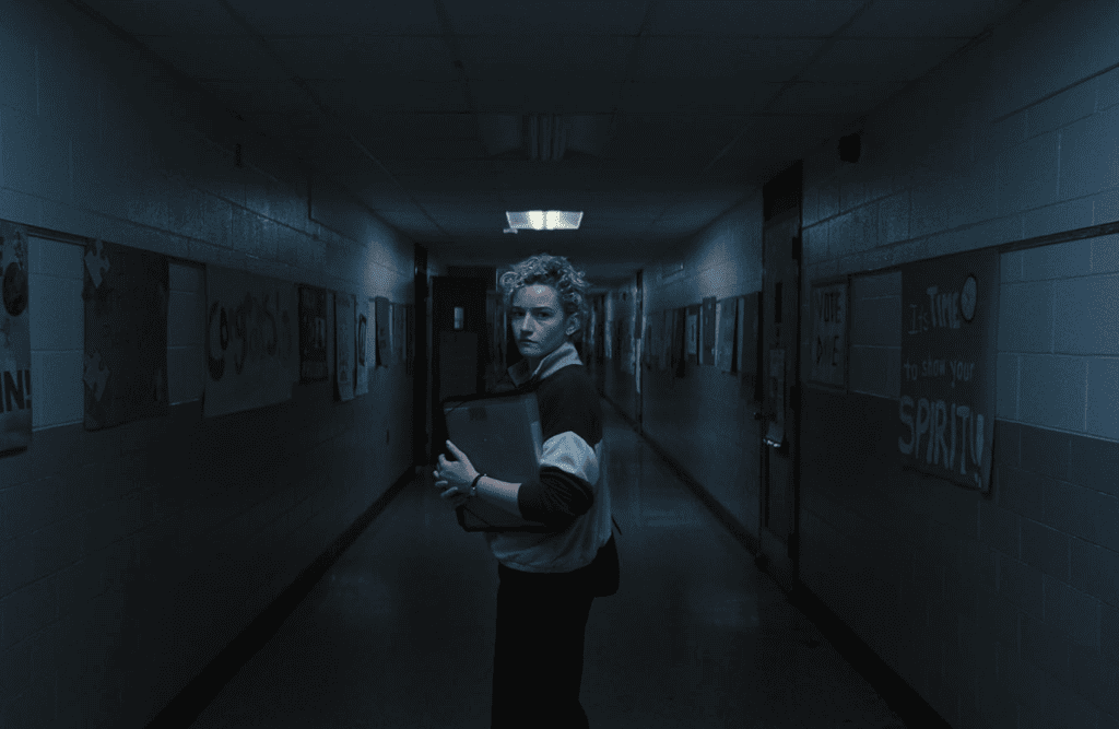 Student in school corridor holding notebook, dim lighting, motivational posters, best of 2025.