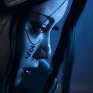 Cyberpunk female gamer with neon makeup, headphones, and intense focus in a dark setting.