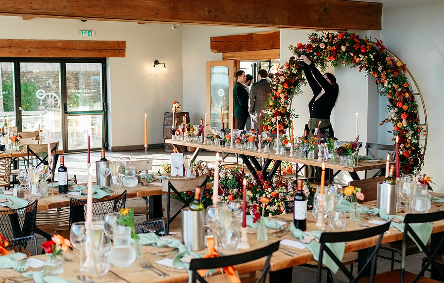 Rebecca Lloyd photographing a table set up at a wedding
