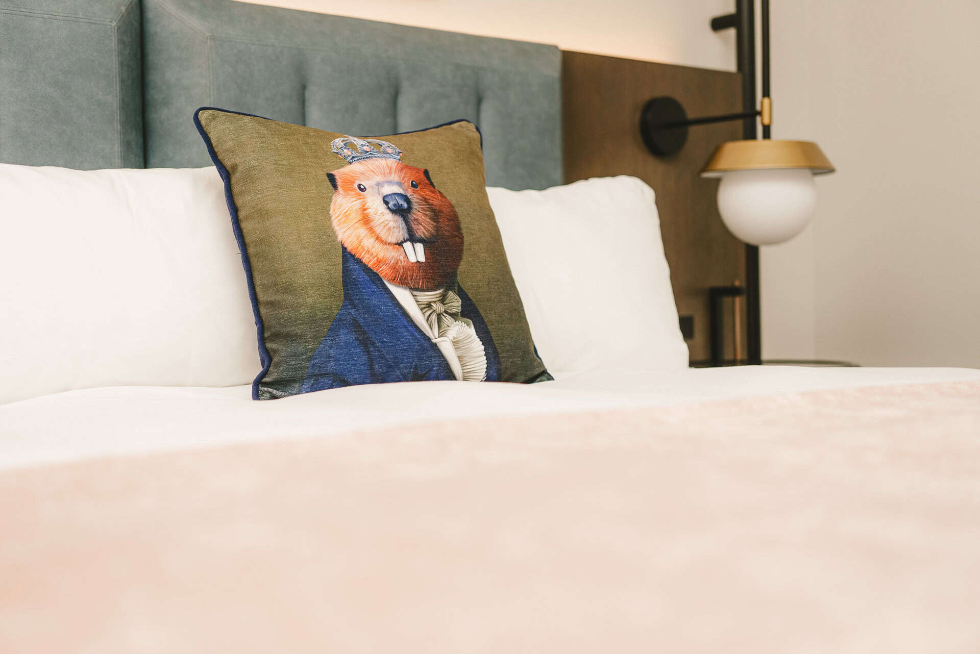 A room at The Royal Sonesta Capitol Hill featuring a pillow with a mascot design.