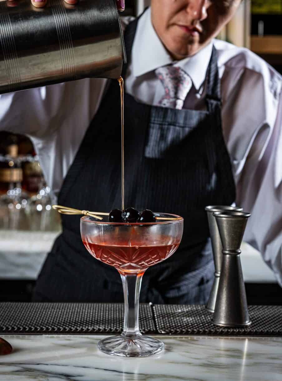 Image of a bartender pouring a drink.