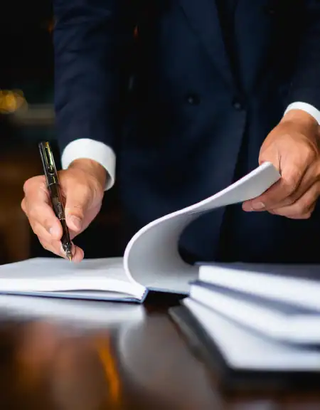 Person-In-Suit-Signing-Legal-Documents