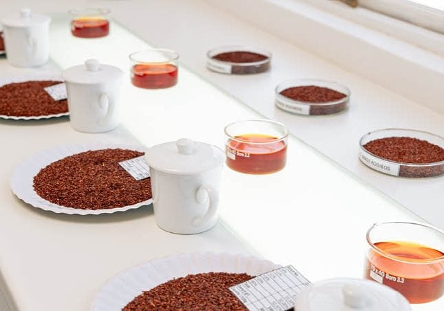 Various cuts of rooibos tea are laid out for grading and testing